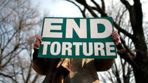 "End torture" sign