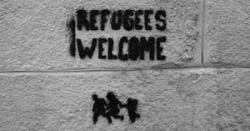 "Refugees Welcome" spray painted on wall