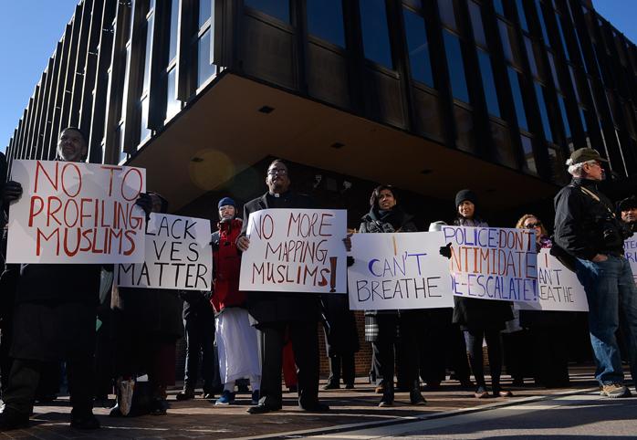 Demonstrators hold signs outside the courthouse