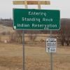 A sign marking the entrance to the Standing Rock reservation, behind which the Oceti Sakowin camp lies. 